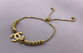 Gold Beaded Slider Bracelet with Iconic Logo Charm