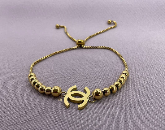 Gold Beaded Slider Bracelet with Iconic Logo Charm