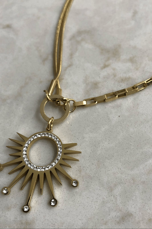 Radiant Sunburst Pendant with Crystal Accents on a Dual Chain Gold Necklace