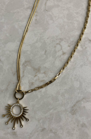 Radiant Sunburst Pendant with Crystal Accents on a Dual Chain Gold Necklace